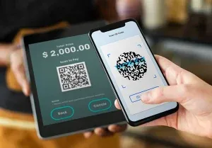 Tablet y celular mostrando un cobro por QR de $2,000.00